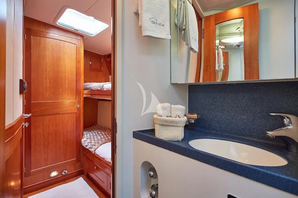 a bathroom with a sink and a mirror aboard DARK STAR OF LONDON Yacht for Charter