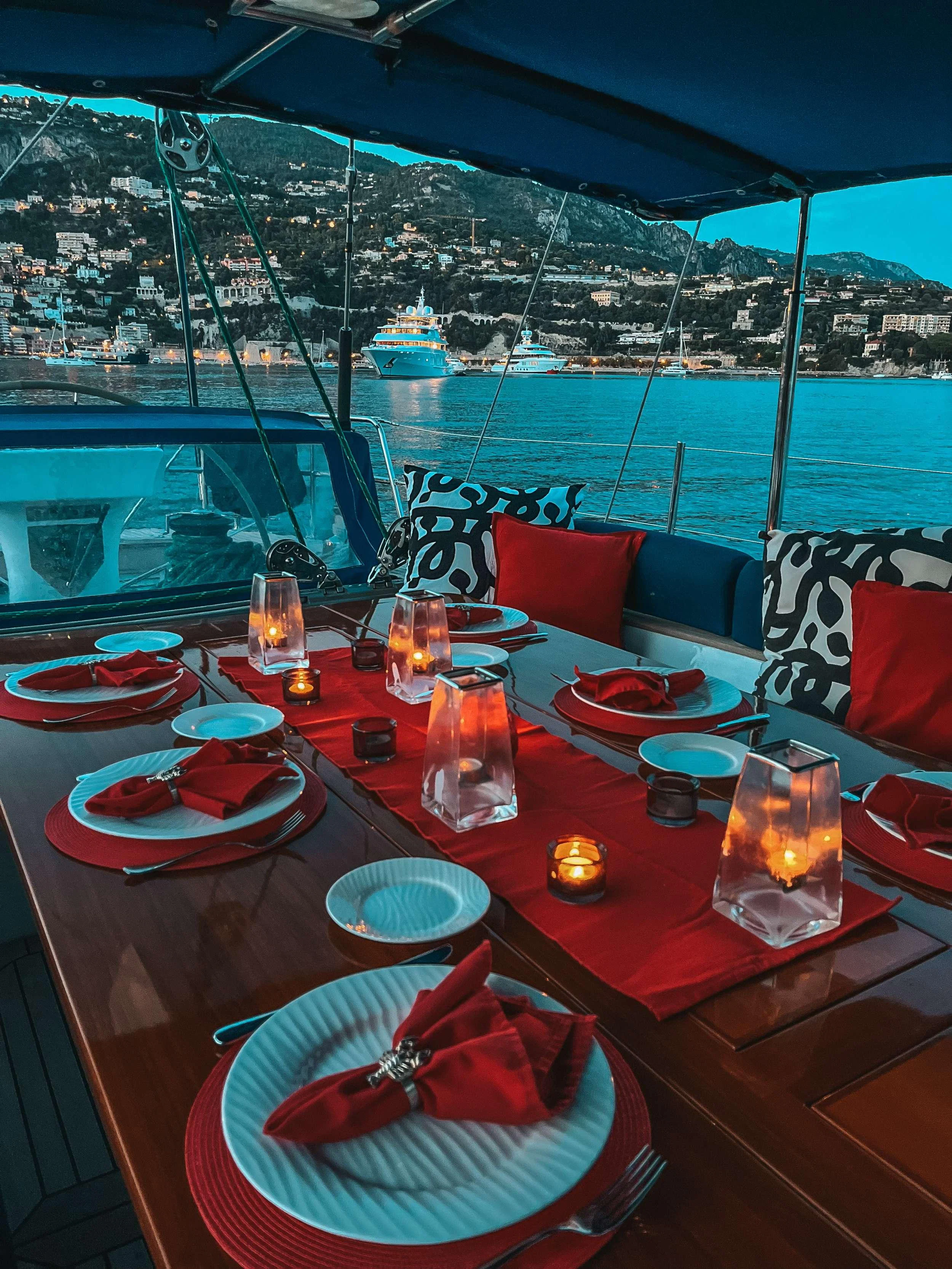a table with plates and glasses on it aboard DARK STAR OF LONDON Yacht for Charter