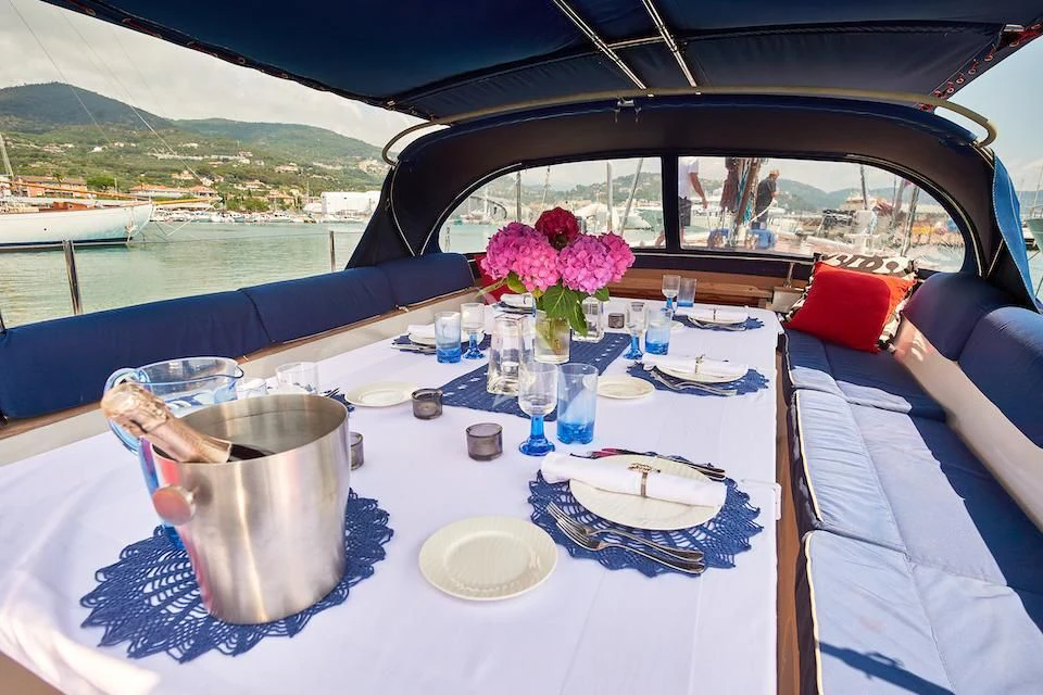a table with plates and glasses on it aboard DARK STAR OF LONDON Yacht for Charter