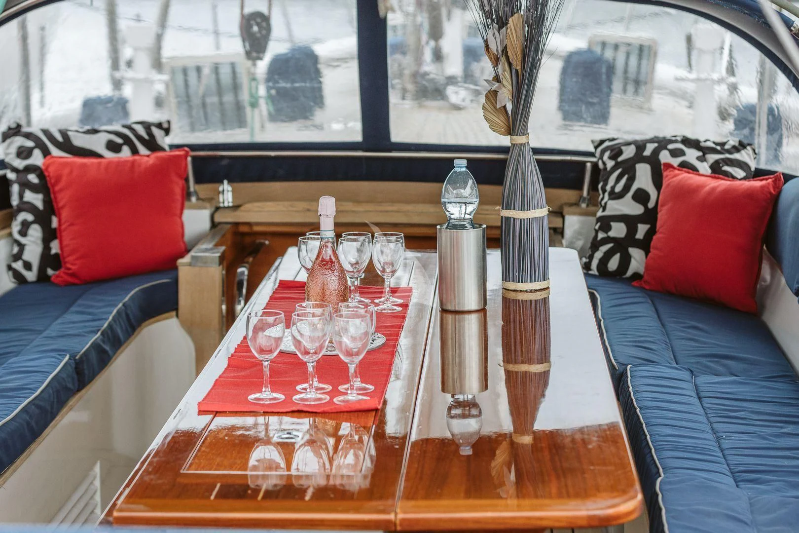 a table with wine glasses and bottles on it aboard DARK STAR OF LONDON Yacht for Charter