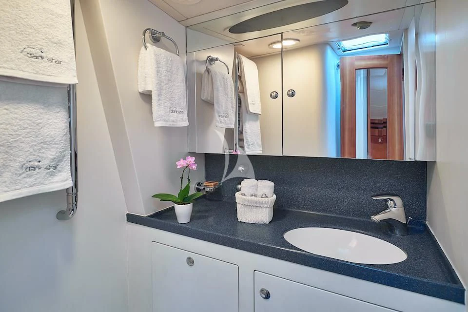 a bathroom with a sink and towels aboard DARK STAR OF LONDON Yacht for Charter