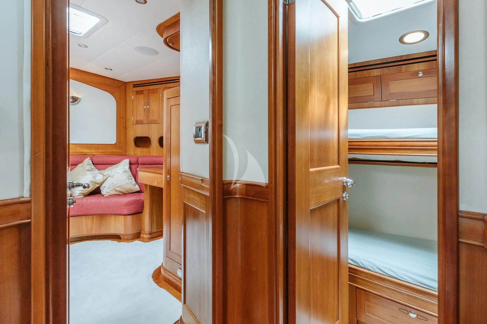 a room with a bed and a closet aboard DARK STAR OF LONDON Yacht for Charter