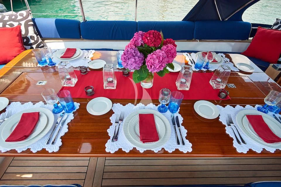 a table set with place settings aboard DARK STAR OF LONDON Yacht for Charter