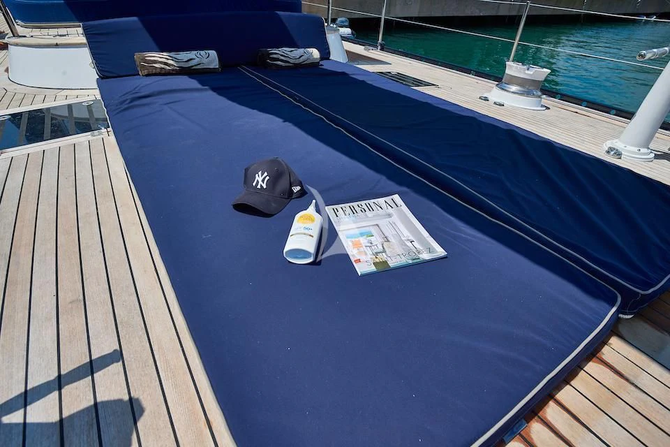 a blue table with a couple of sunglasses on it aboard DARK STAR OF LONDON Yacht for Charter
