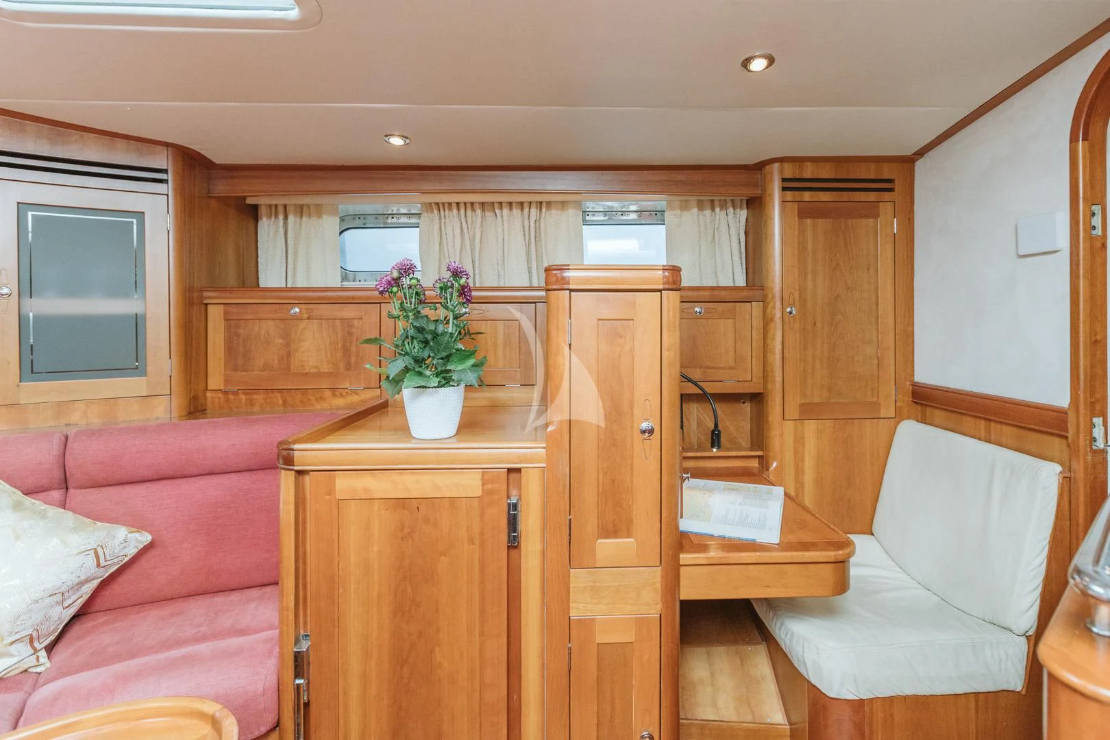 a living room with a couch and a table aboard DARK STAR OF LONDON Yacht for Charter