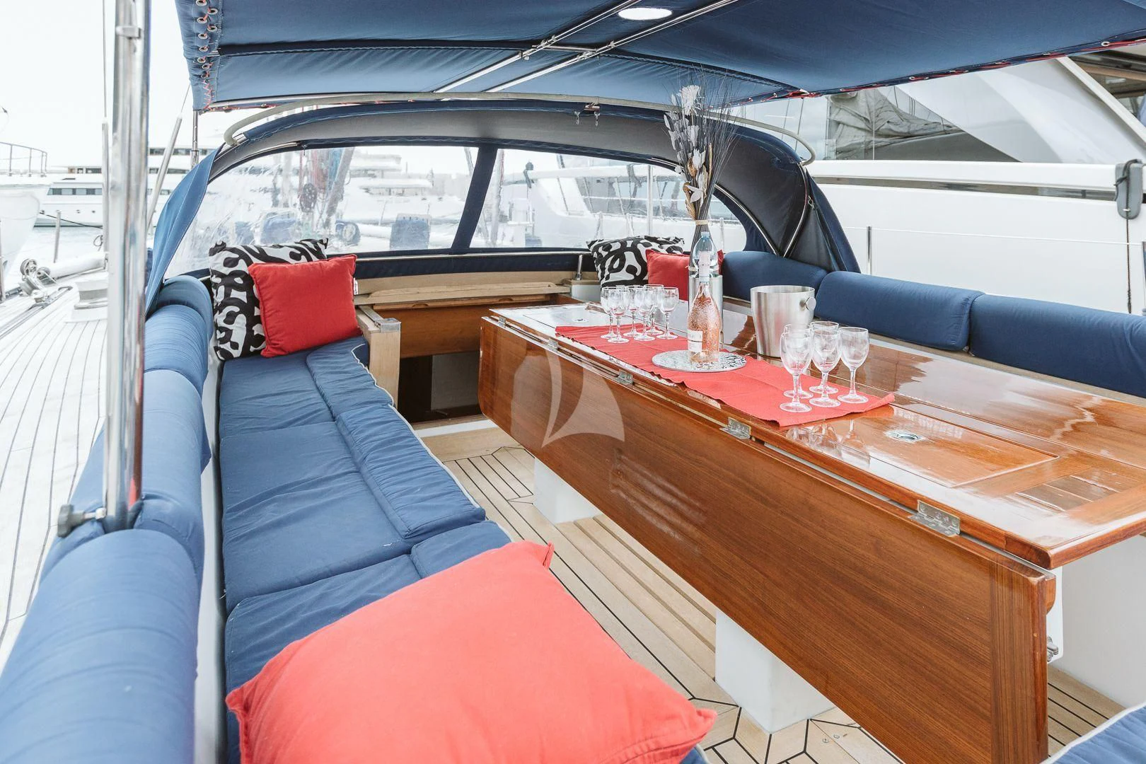 a table with a red cloth on it and a red pillow on it aboard DARK STAR OF LONDON Yacht for Charter