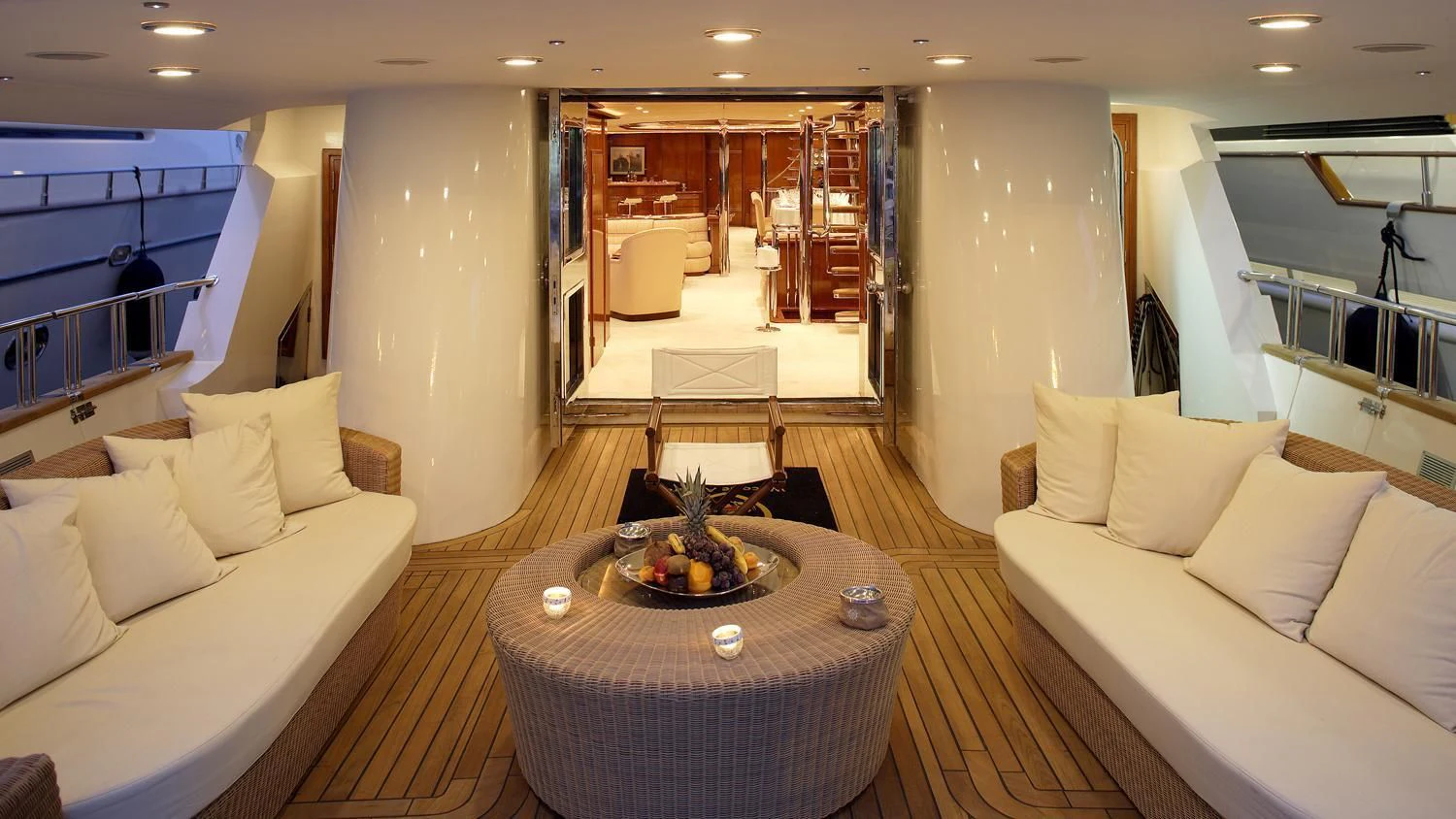a room with a table and couches aboard CORVUS Yacht for Sale