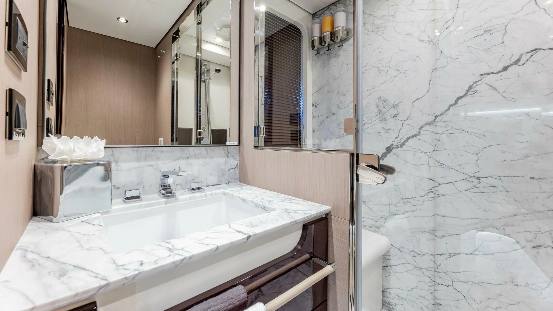 a bathroom with a large mirror aboard CAPTAIN MORGAN II Yacht for Sale