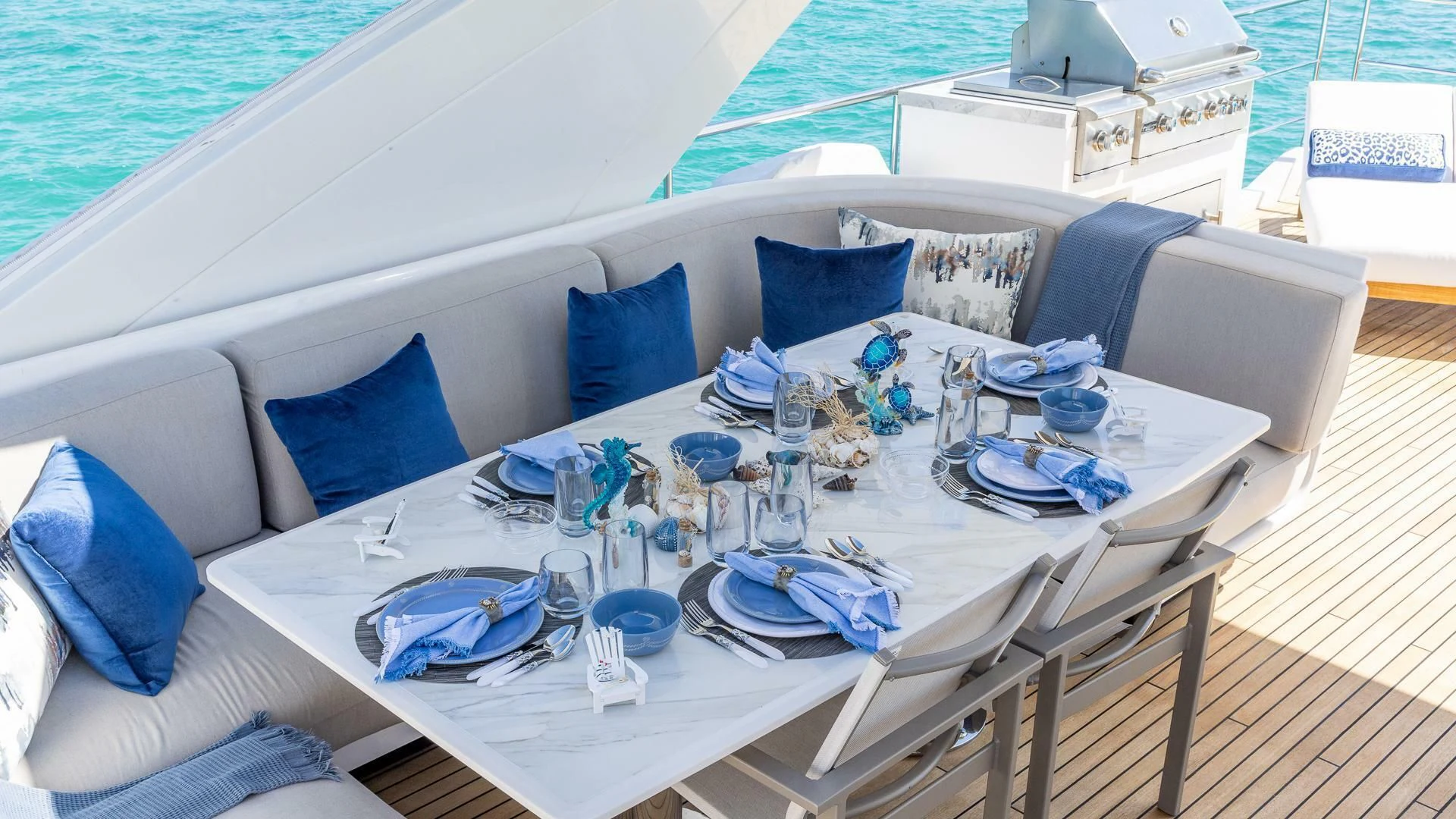 a table with plates and glasses on it aboard CAPTAIN MORGAN II Yacht for Sale
