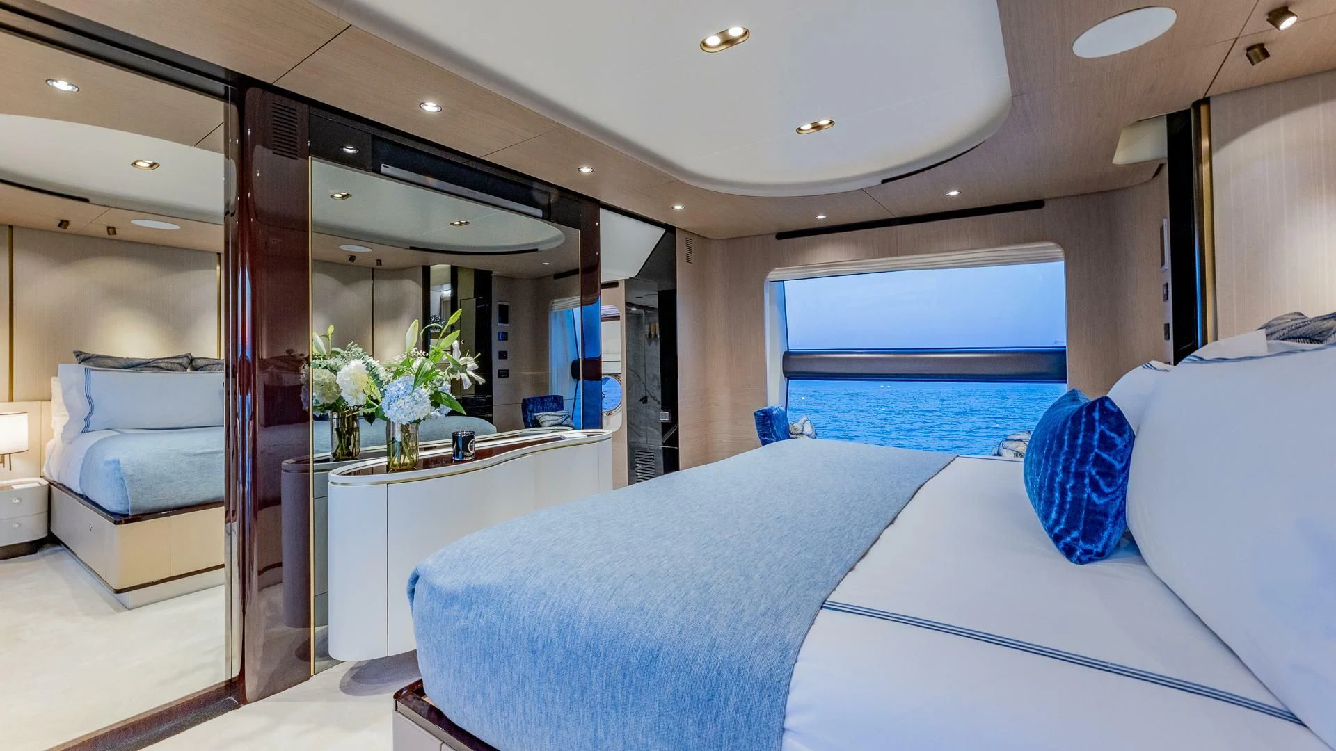 a room with a bed and a mirror aboard CAPTAIN MORGAN II Yacht for Sale