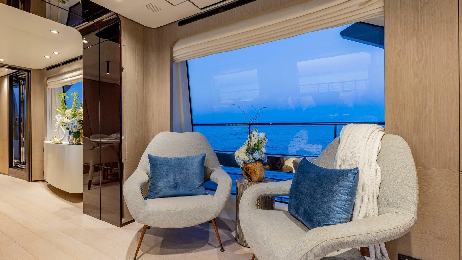 a room with a blue couch and a large blue screen aboard CAPTAIN MORGAN II Yacht for Sale