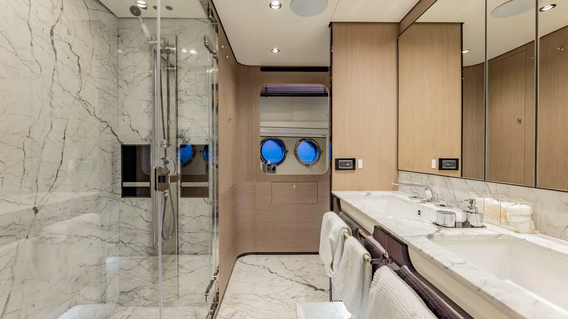 a bathroom with a shower and sinks aboard CAPTAIN MORGAN II Yacht for Sale