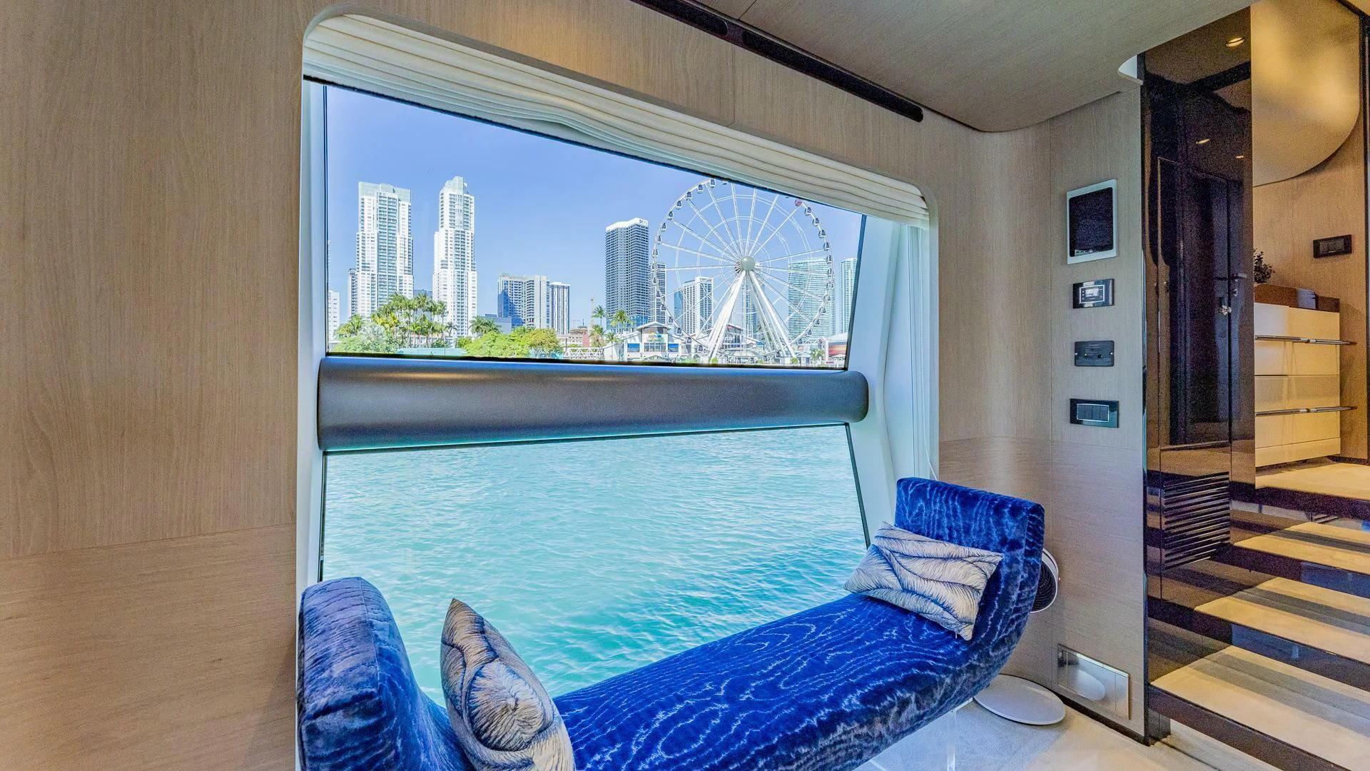 a room with a large blue bed and a large window aboard CAPTAIN MORGAN II Yacht for Sale