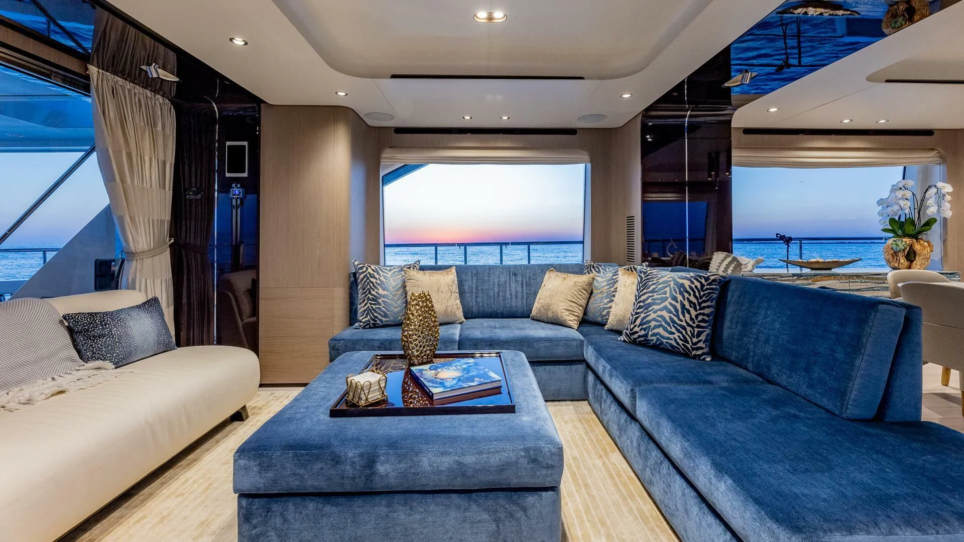 a living room with a blue couch aboard CAPTAIN MORGAN II Yacht for Sale