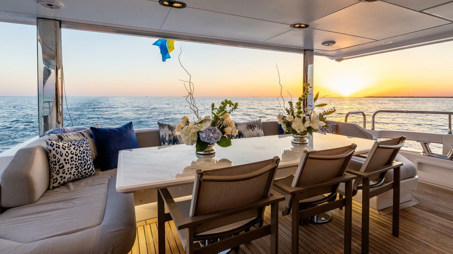 a table and chairs on a deck aboard CAPTAIN MORGAN II Yacht for Sale