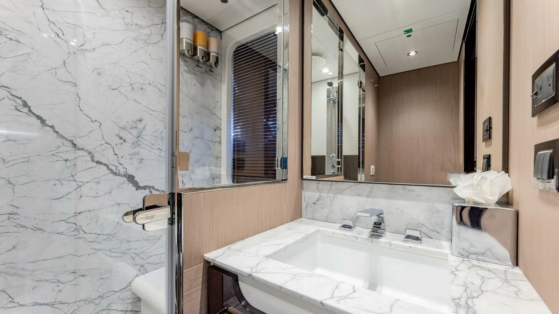 a bathroom with a large mirror aboard CAPTAIN MORGAN II Yacht for Sale