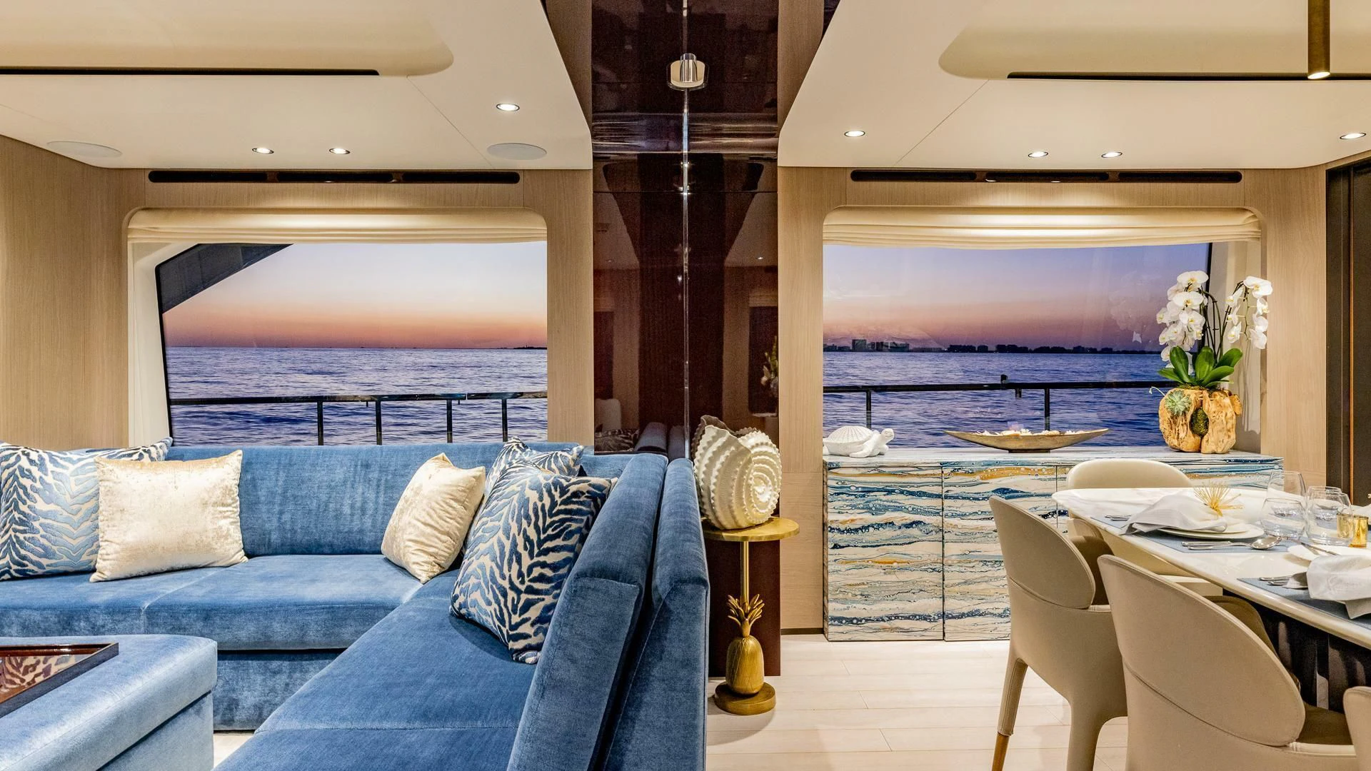 a room with a couch and a table and chairs aboard CAPTAIN MORGAN II Yacht for Sale