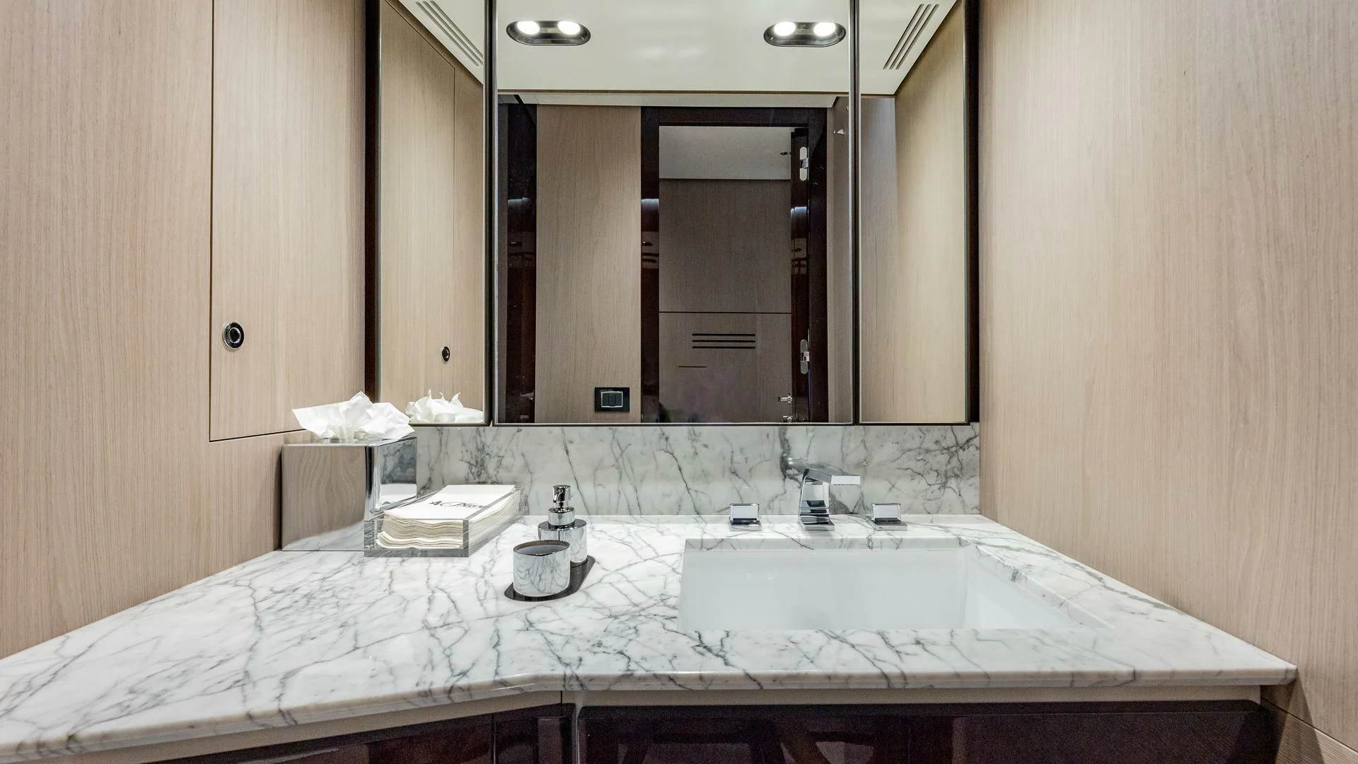 a bathroom with a large mirror aboard CAPTAIN MORGAN II Yacht for Sale