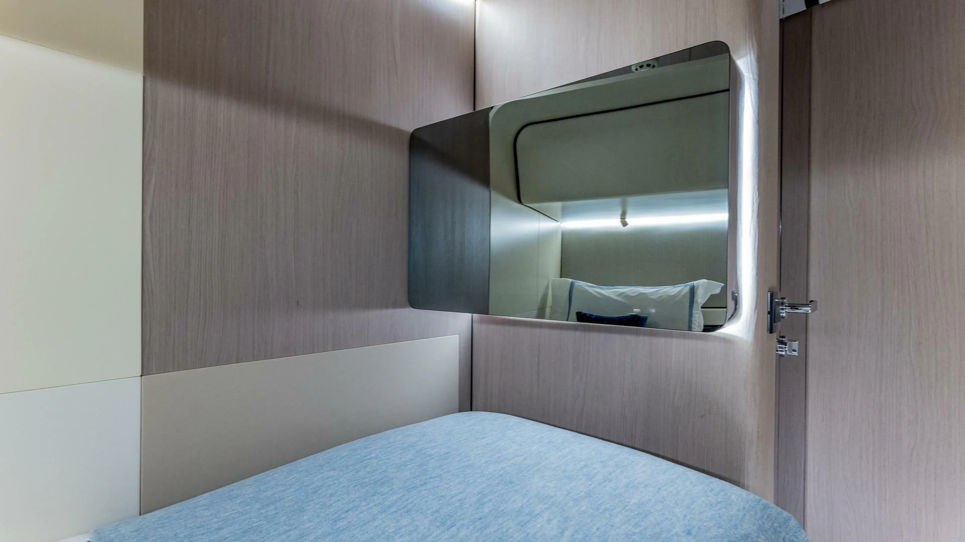 a bed with a blue blanket aboard CAPTAIN MORGAN II Yacht for Sale