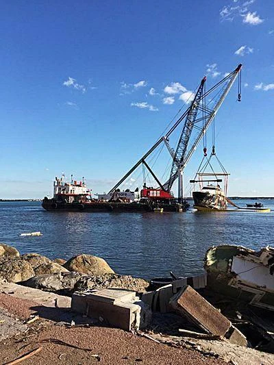 a crane near a body of water aboard SUEGNO Yacht for Sale