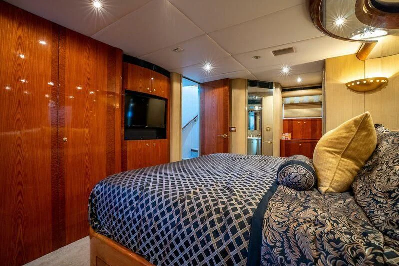 a bedroom with a bed and a wood wall aboard SELF MADE Yacht for Sale