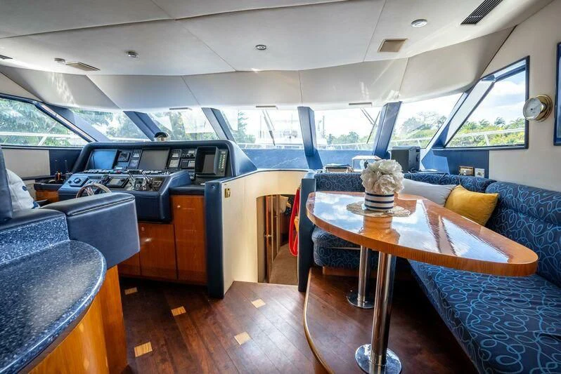 a boat with a table and chairs aboard SELF MADE Yacht for Sale