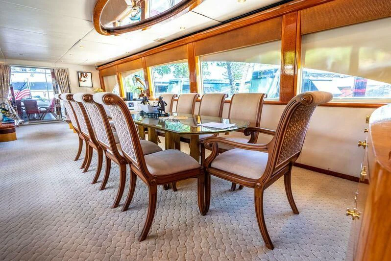 a dining room with a table and chairs aboard SELF MADE Yacht for Sale