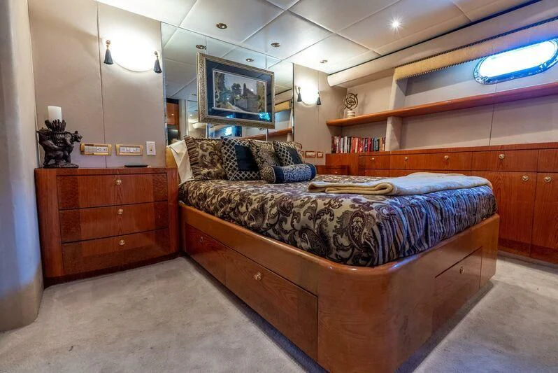 a bedroom with a bed and a dresser aboard SELF MADE Yacht for Sale