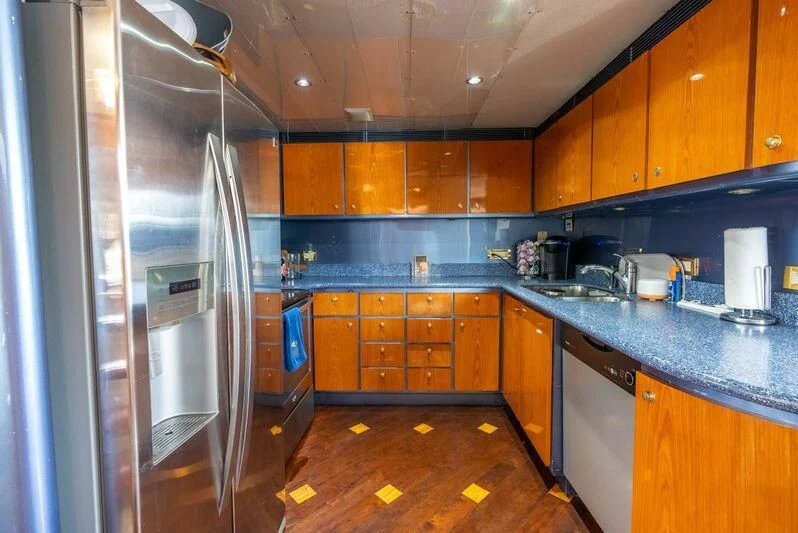 a kitchen with stainless steel appliances aboard SELF MADE Yacht for Sale