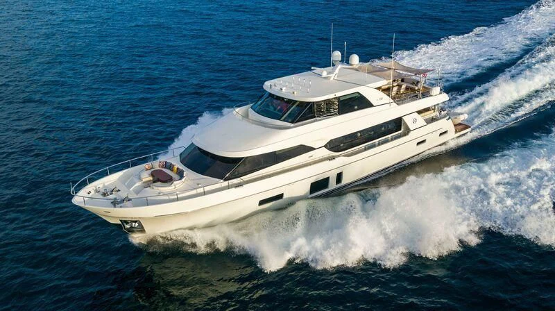a white yacht on the water aboard AURA Yacht for Sale