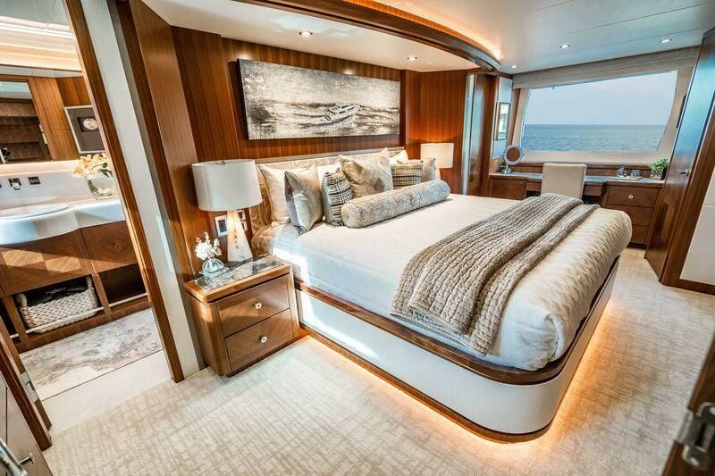 a bedroom with a bed and a sink aboard AURA Yacht for Sale