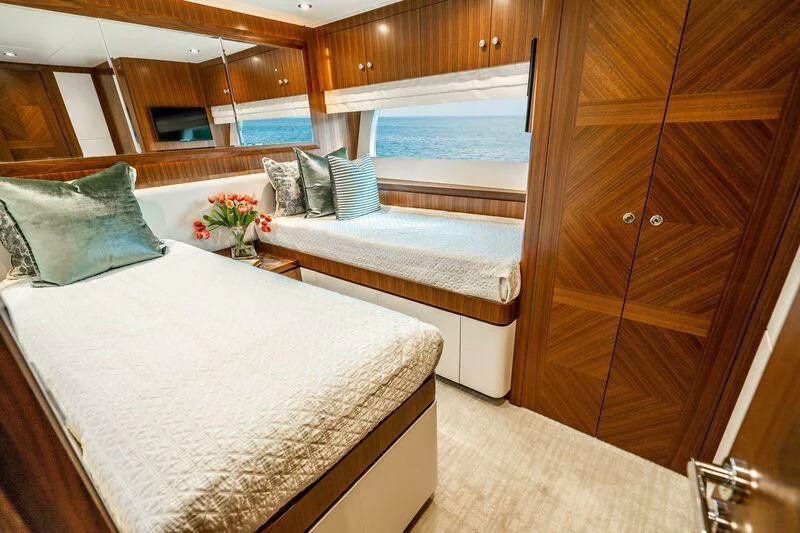 a room with a bed and a window aboard AURA Yacht for Sale