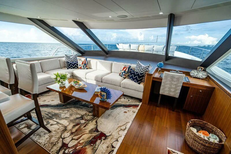 a living room with a large window aboard AURA Yacht for Sale