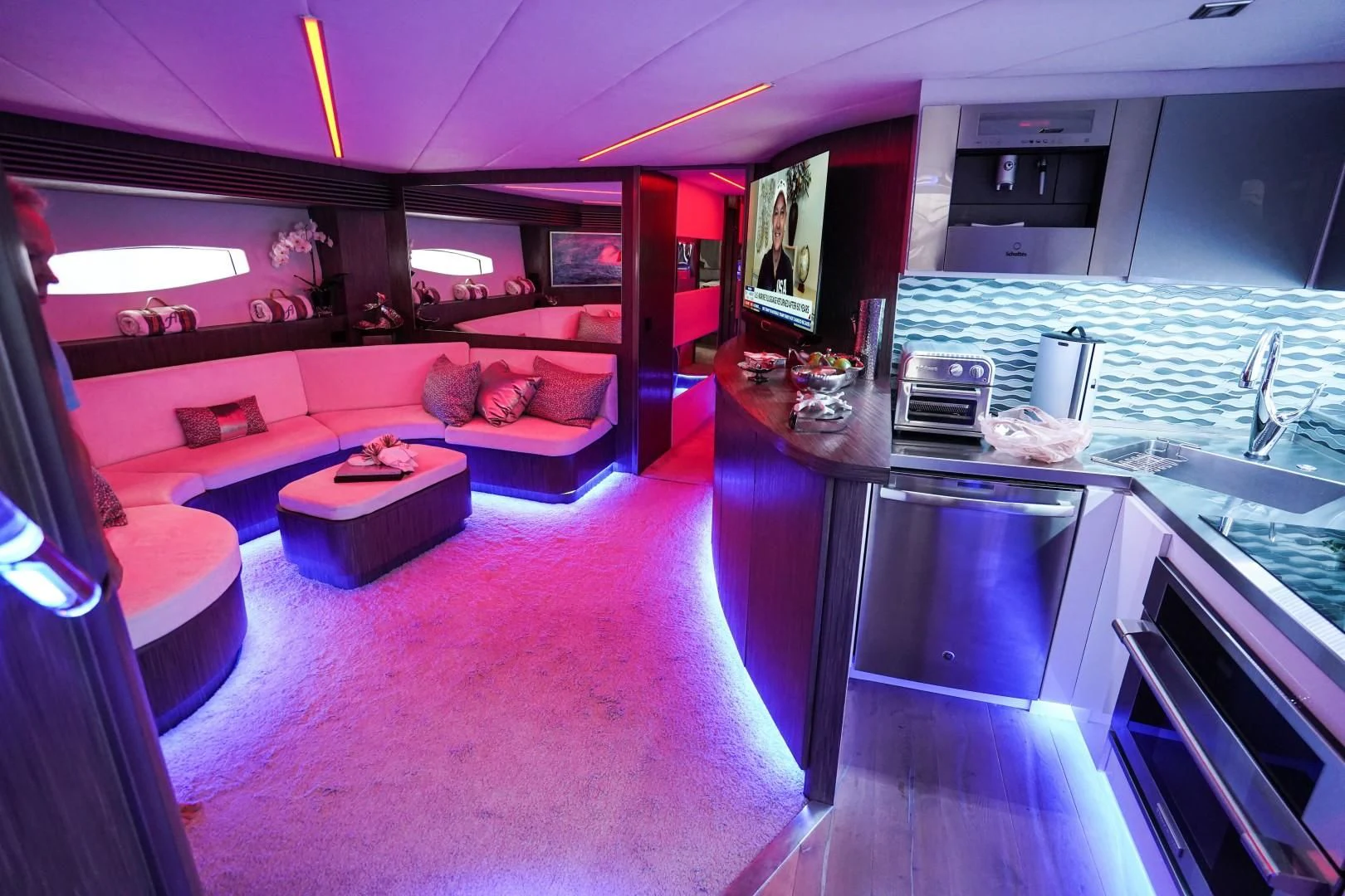 a kitchen with a purple couch aboard AMORA Yacht for Sale