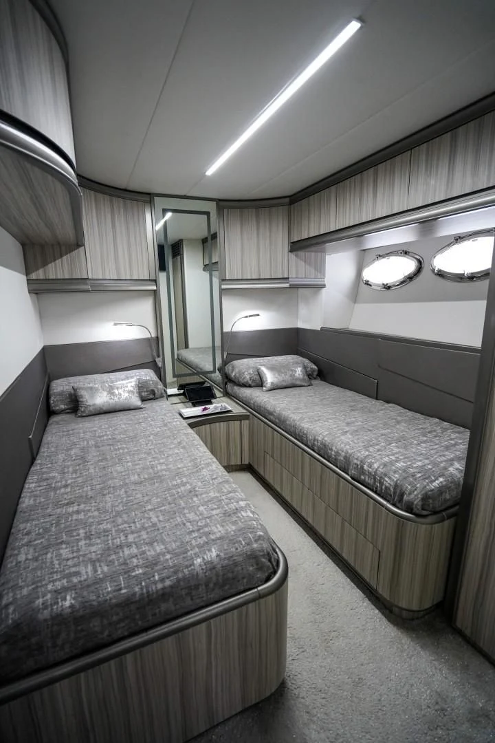 a bedroom with two beds aboard AMORA Yacht for Sale
