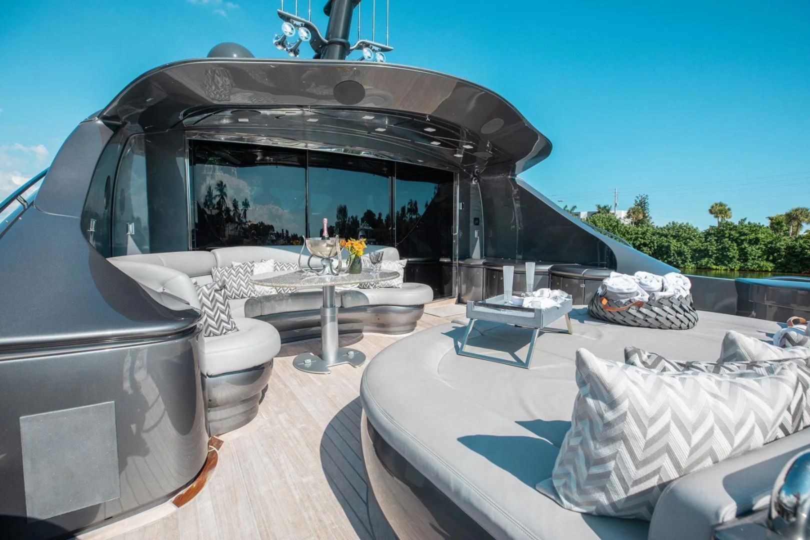 a white bed next to a white car aboard AMORA Yacht for Sale