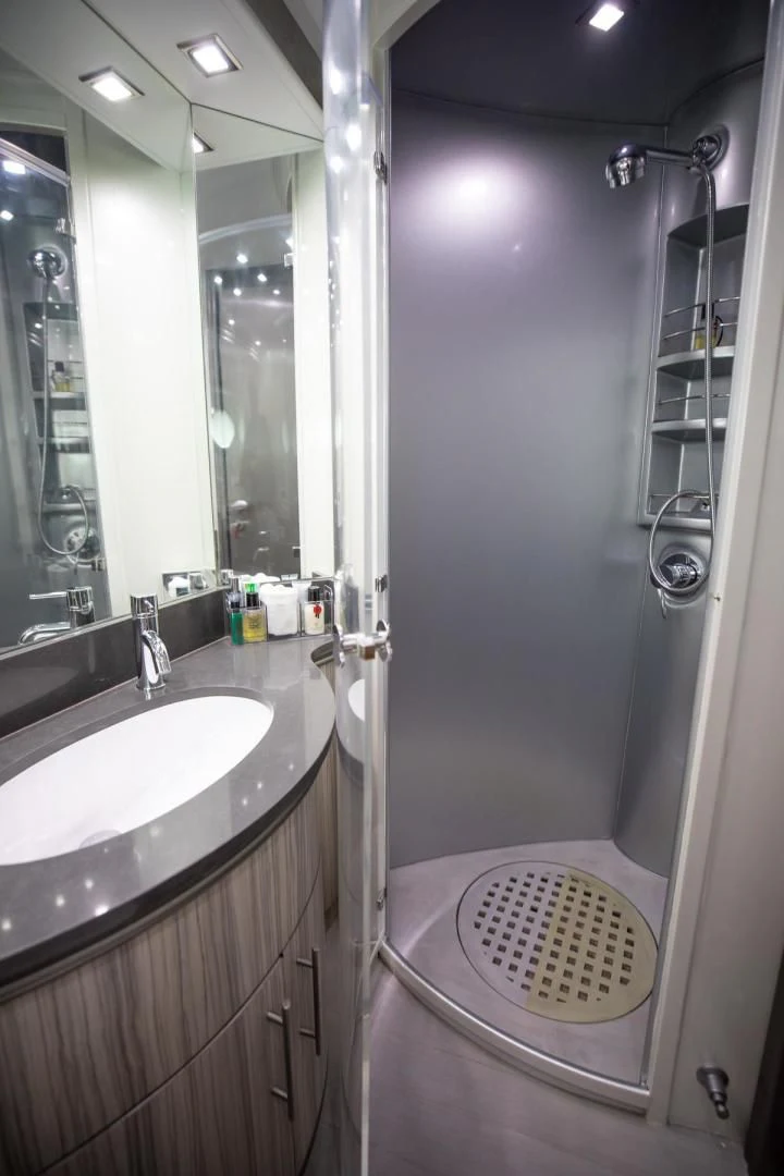 a bathroom with a shower and sink aboard AMORA Yacht for Sale