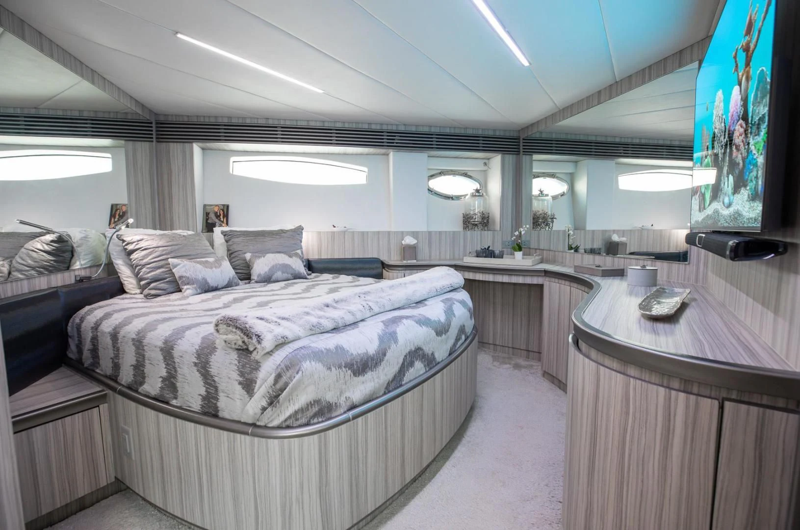 a bedroom with a bed and a desk aboard AMORA Yacht for Sale