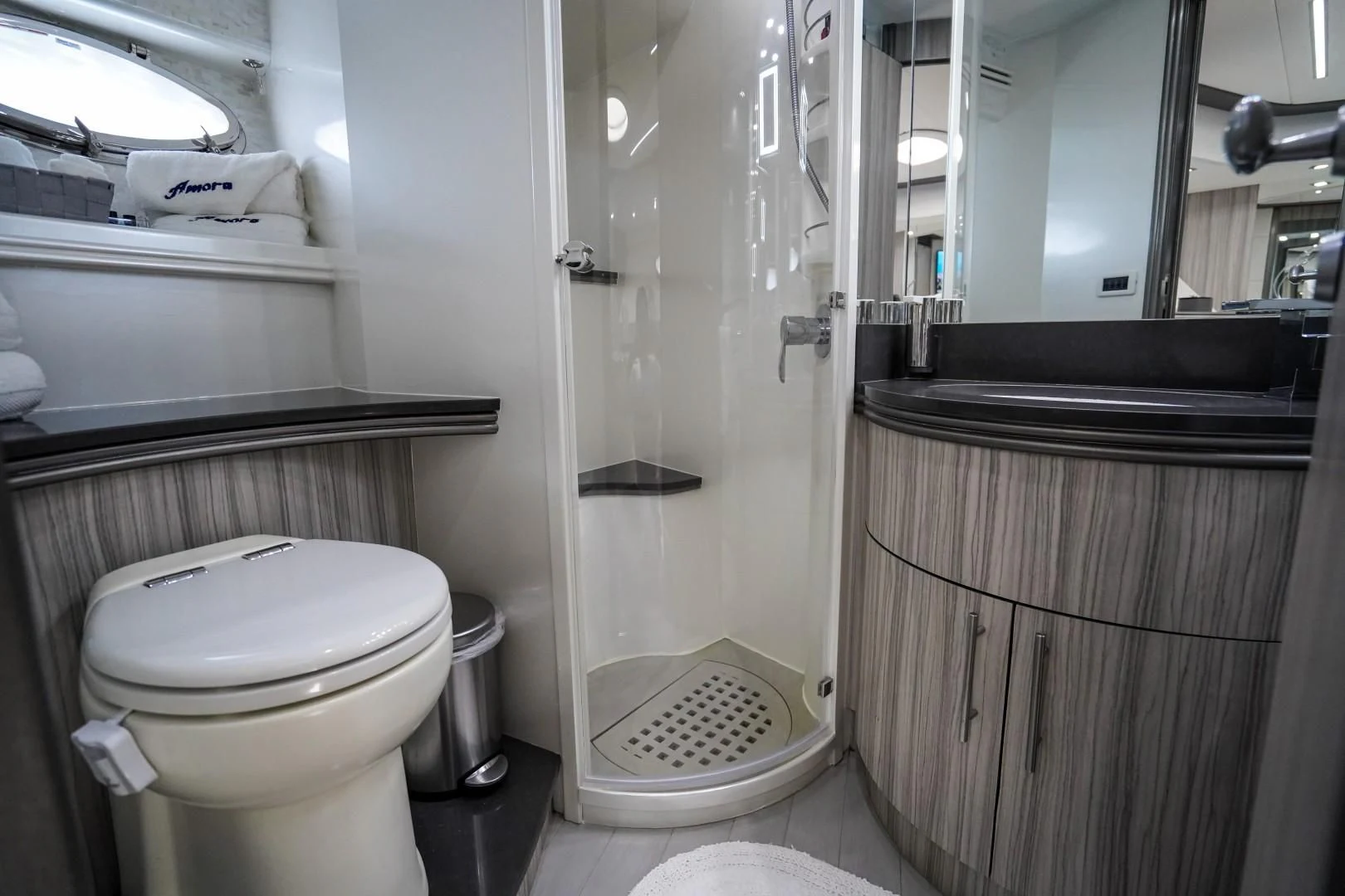 a bathroom with a toilet and a shower aboard AMORA Yacht for Sale