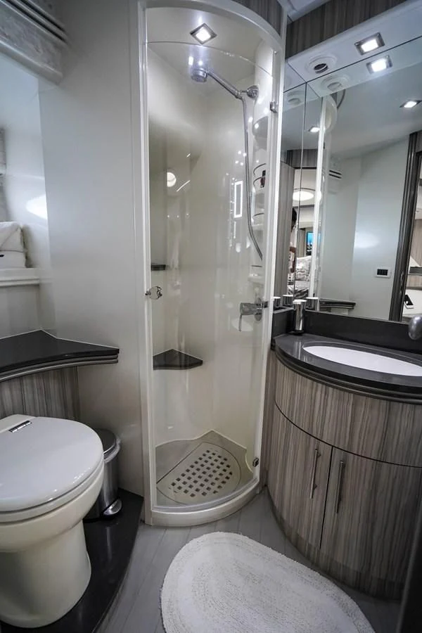a bathroom with a shower and a toilet aboard AMORA Yacht for Sale