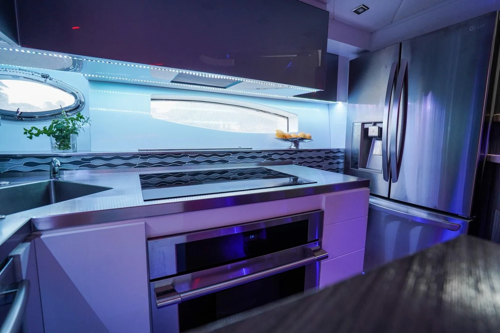 a kitchen with purple cabinets aboard AMORA Yacht for Sale