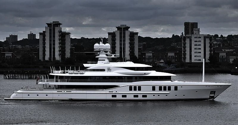 a large white boat on a river aboard SIXTH SENSE Yacht for Sale