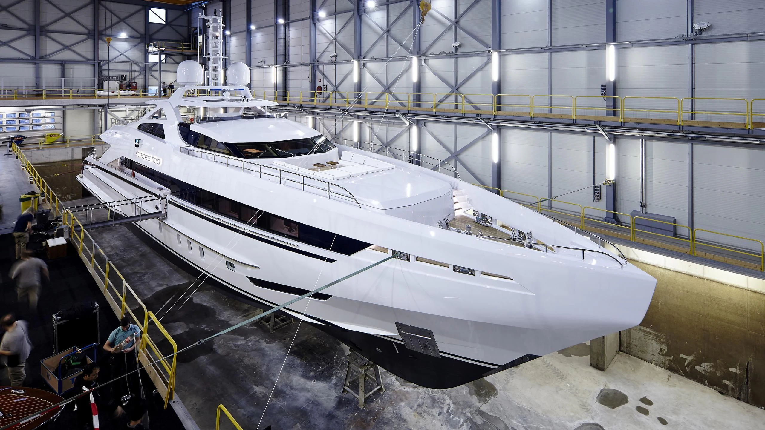 a large white boat in a building aboard AMORE MIO Yacht for Sale