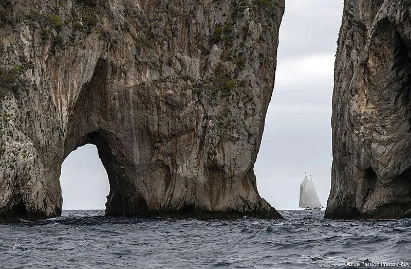 a large rock arch over a body of water aboard PURITAN Yacht for Sale