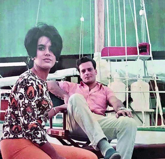 a man and a woman sitting on a bench in a playground aboard PURITAN Yacht for Sale