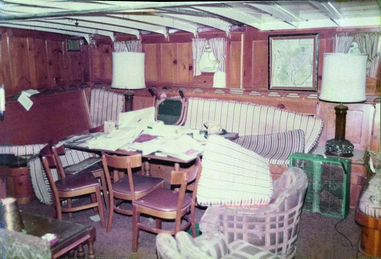 a room with a table chairs and a bed aboard PURITAN Yacht for Sale