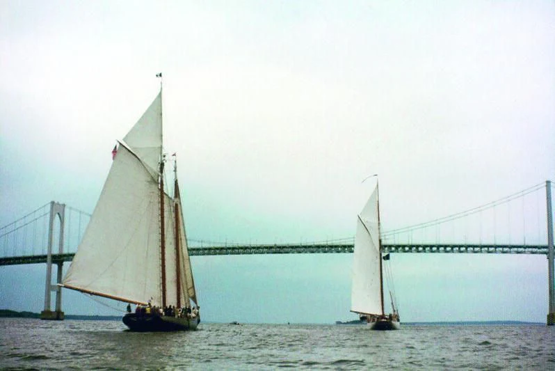 a couple of sailboats on the water aboard PURITAN Yacht for Sale