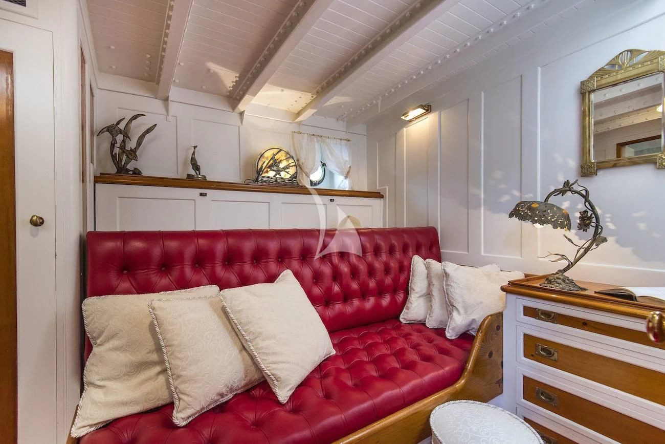 a living room with a red couch aboard PURITAN Yacht for Sale