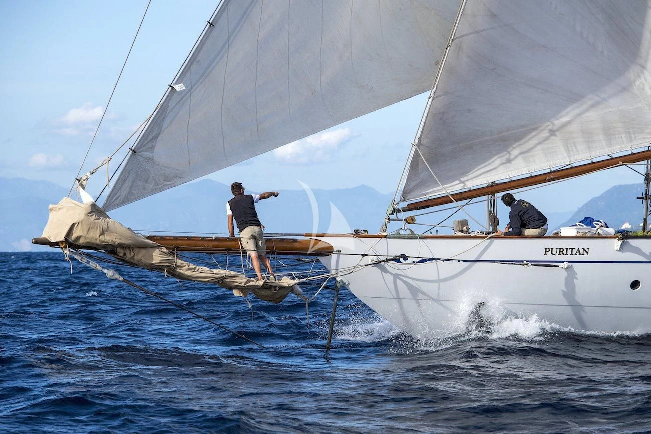 a couple of men on a sailboat aboard PURITAN Yacht for Sale