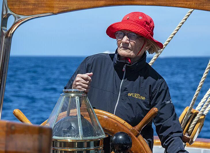 a man in a red hat on a boat aboard PURITAN Yacht for Sale